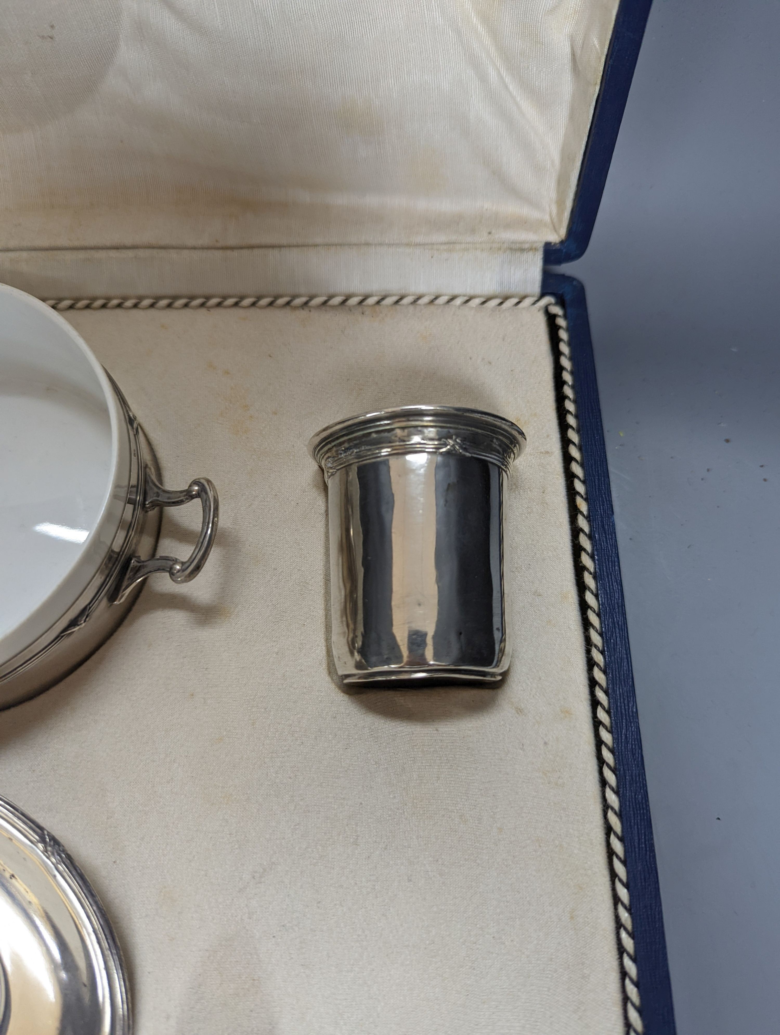 A cased part German 800 white metal mounted ceramic part tea set (incomplete), metal weight 5.5oz.